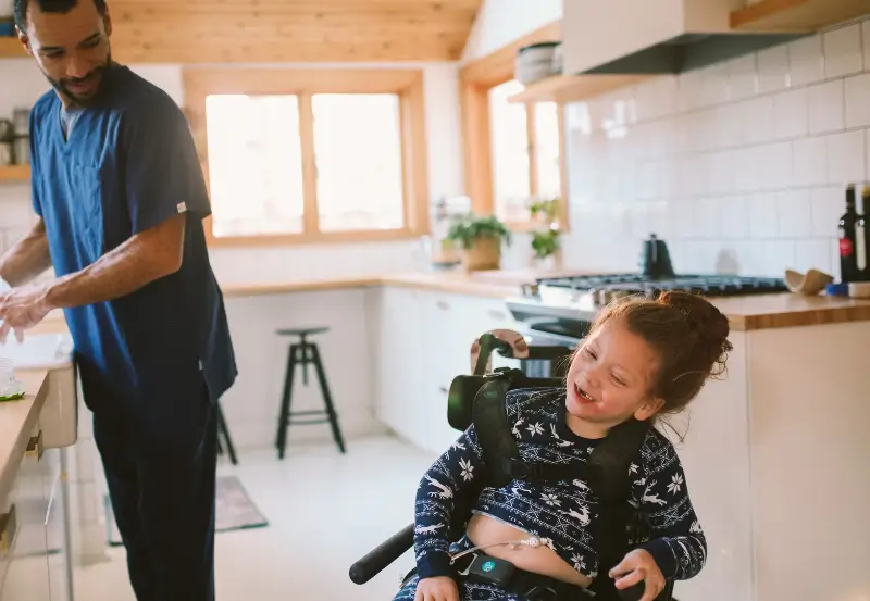 child with Mic button in kitchen